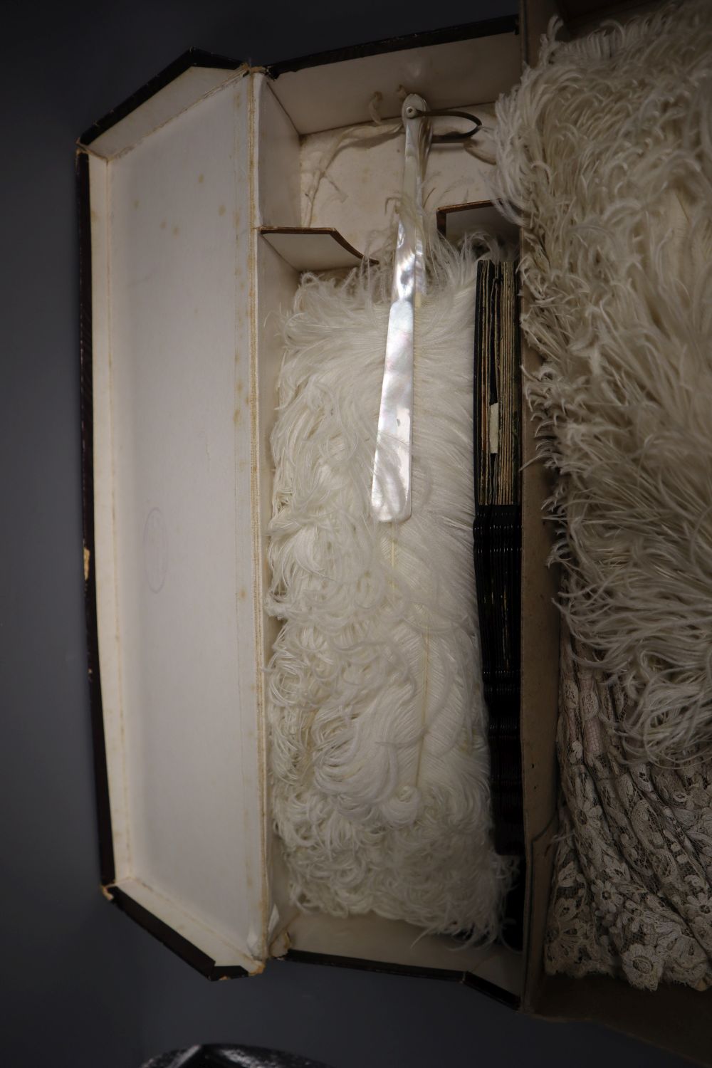 A collection of fans and a lace parasol